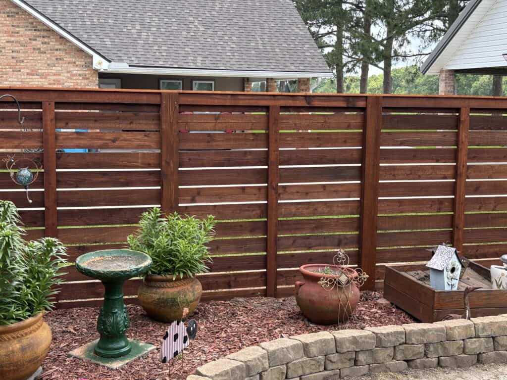 Newly installed prestained cedar wood privacy fence in Lafayette backyard — professional fence installation by Basin Fence